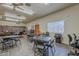 A recreation room featuring multiple tables and chairs, bookshelves, and a bright open space at 3330 E Main St # 7, Mesa, AZ 85213