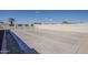 An exterior view of shuffleboard courts with benches and a palm tree under a clear blue sky at 3330 E Main St # 7, Mesa, AZ 85213