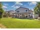 Expansive backyard with lush lawn, covered patio, string lights, and ample space for outdoor activities at 3336 E Linda Ct, Gilbert, AZ 85234