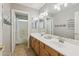 Bathroom featuring a double vanity, bright lighting, and a view of the shower and toilet at 3336 E Linda Ct, Gilbert, AZ 85234