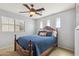 Bedroom featuring a stylish ceiling fan, decorative headboard, and comfortable bedding at 3336 E Linda Ct, Gilbert, AZ 85234