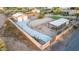 Aerial view of a fenced property showcasing a metal barn, concrete driveway, equestrian facilities, and landscaping at 38301 N 15Th Ave, Phoenix, AZ 85086