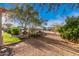 The desert landscape backyard is a mix of lush green grass, mature trees and desert landscaping at 38301 N 15Th Ave, Phoenix, AZ 85086