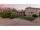 A desert-landscaped yard with green grass, featuring a desert-landscaped yard with a covered patio at 38301 N 15Th Ave, Phoenix, AZ 85086