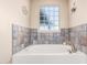 Relaxing bathroom showcasing a soaking tub with decorative tile surround at 38301 N 15Th Ave, Phoenix, AZ 85086