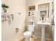 Clean half bath with pedestal sink, standard toilet, and neutral decor at 38301 N 15Th Ave, Phoenix, AZ 85086