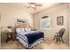 Comfortable bedroom featuring a window with plantation shutters, neutral color palette, tile floors, and a ceiling fan at 38301 N 15Th Ave, Phoenix, AZ 85086