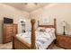 Cozy bedroom featuring a wooden four-poster bed and matching furniture at 38301 N 15Th Ave, Phoenix, AZ 85086