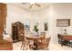 Cozy dining room features tile flooring, ample natural light, and a vintage display cabinet at 38301 N 15Th Ave, Phoenix, AZ 85086