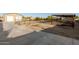 Outdoor equestrian facility with a covered pen, metal fencing, a barn, and a concrete driveway on a sprawling lot at 38301 N 15Th Ave, Phoenix, AZ 85086