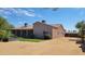 Back exterior featuring a desert landscaped yard, a covered patio and easy access to a covered parking area at 38301 N 15Th Ave, Phoenix, AZ 85086