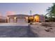 Home with desert landscaping, three car garage, tile roof, and unique architectural design at 38301 N 15Th Ave, Phoenix, AZ 85086