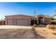 Exterior of this desert home features a three-car garage and xeriscaping at 38301 N 15Th Ave, Phoenix, AZ 85086