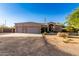 Expansive exterior of this desert home features a three car garage and low maintenance landscaping at 38301 N 15Th Ave, Phoenix, AZ 85086