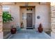 Inviting entryway features a decorative door, potted plants and a charming welcome mat at 38301 N 15Th Ave, Phoenix, AZ 85086