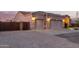 Exterior shot of home with three car garage, desert landscaping and concrete driveway at 38301 N 15Th Ave, Phoenix, AZ 85086