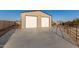 Spacious two-car garage with concrete driveway for vehicles and outdoor equipment storage at 38301 N 15Th Ave, Phoenix, AZ 85086