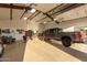 Spacious garage with a high ceiling, epoxy floors, and a large truck parked inside, suitable for a workshop at 38301 N 15Th Ave, Phoenix, AZ 85086