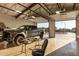 Bright garage interior with a car, epoxy floor, and an open door showing the property, perfect for car enthusiasts at 38301 N 15Th Ave, Phoenix, AZ 85086