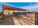 Large horse paddock area featuring a covered shelter and fencing, providing a safe and comfortable space for animals at 38301 N 15Th Ave, Phoenix, AZ 85086