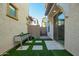 Cozy backyard featuring artificial turf, stepping stones, and a raised metal planter box at 4110 S 58Th Ln, Phoenix, AZ 85043