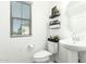 Powder room featuring a stylish sink, toilet, and decorative shelves, offering a convenient and aesthetically pleasing space at 4110 S 58Th Ln, Phoenix, AZ 85043