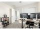 Bright home office with dual monitors, modern desk, and ample storage providing an efficient workspace at 4110 S 58Th Ln, Phoenix, AZ 85043