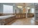 Bathroom with double sink vanity, soaking tub, and large mirror at 4417 W Lawler Loop, Phoenix, AZ 85083