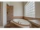 Bathroom with large tub under glass block window and shower at 4417 W Lawler Loop, Phoenix, AZ 85083