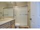 Bathroom featuring wooden cabinets, modern fixtures, and a glass standing shower at 4417 W Lawler Loop, Phoenix, AZ 85083