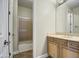 Bathroom featuring wooden cabinets, modern fixtures, a mirror, and a standing shower at 4417 W Lawler Loop, Phoenix, AZ 85083