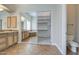 Bathroom featuring double sink vanity and large walk-in closet with built-in shelves at 4417 W Lawler Loop, Phoenix, AZ 85083