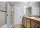 Bright bathroom featuring wooden cabinets, modern fixtures, a mirror, and a standing shower at 4417 W Lawler Loop, Phoenix, AZ 85083