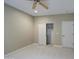 Neutral bedroom features a ceiling fan, closet, and plush carpet at 4417 W Lawler Loop, Phoenix, AZ 85083