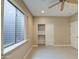 Bedroom featuring plush carpet, large window, and ceiling fan at 4417 W Lawler Loop, Phoenix, AZ 85083