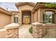 Inviting front entryway with stone pillars and a decorative wooden door at 4417 W Lawler Loop, Phoenix, AZ 85083