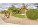 Well-manicured front yard featuring mature palm trees and lush green grass at 4417 W Lawler Loop, Phoenix, AZ 85083