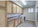 Functional laundry room with sink, cabinetry, and white front-load washer at 4417 W Lawler Loop, Phoenix, AZ 85083