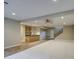 Open-concept living space with carpet and tile flooring, leading to a kitchen area with bar seating at 4417 W Lawler Loop, Phoenix, AZ 85083