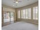 Living room with carpet, tile, fireplace, sliding doors to patio, and plantation shutters at 4417 W Lawler Loop, Phoenix, AZ 85083