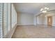 Bright living room featuring tile floors, large windows with plantation shutters, and neutral paint at 4417 W Lawler Loop, Phoenix, AZ 85083