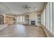 Open-concept living room featuring fireplace, custom built-ins, tile floors, and plantation shutters at 4417 W Lawler Loop, Phoenix, AZ 85083