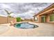 Backyard pool with rock waterfall feature and desert landscaping, perfect for outdoor entertaining at 4417 W Lawler Loop, Phoenix, AZ 85083