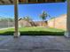 Lush backyard featuring green grass, tall privacy walls, and two palm trees at 4546 N 84Th Ln, Phoenix, AZ 85037