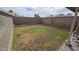 Large backyard with block fencing, a grassy area, and ample space for outdoor activities at 4546 N 84Th Ln, Phoenix, AZ 85037