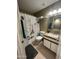 Well-lit bathroom with granite countertops, neutral walls, and tile flooring at 4546 N 84Th Ln, Phoenix, AZ 85037