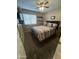 This bedroom is cozy, featuring a ceiling fan, and a window with blinds at 4546 N 84Th Ln, Phoenix, AZ 85037