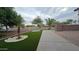 Well maintained front yard featuring a desert landscape, artificial turf, and a decorative stone border at 4546 N 84Th Ln, Phoenix, AZ 85037