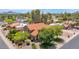 Expansive aerial view showcases the home's red tile roof, lush surroundings, and community at 5045 E Redfield Rd, Scottsdale, AZ 85254