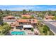 Aerial view of the property featuring a pool, multiple patios, lush landscaping, and tile roof at 5045 E Redfield Rd, Scottsdale, AZ 85254